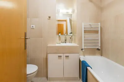 a bathroom with a tub and a toilet and a sink at Porto Stay no Marques with AC and parking place in Porto