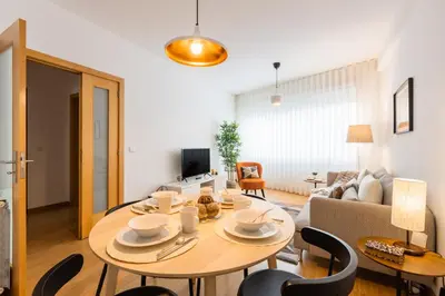 a living room with a table and a couch at Porto Stay no Marques with AC and parking place in Porto