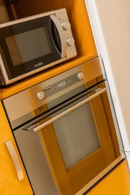a microwave on top of an oven in a kitchen at Porto Stay no Marques with AC and parking place in Porto