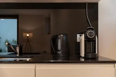 a kitchen counter with a coffee maker and a coffee pot at Central Porto Hideaway with Sunny Terrace by Lisbeyond in Porto