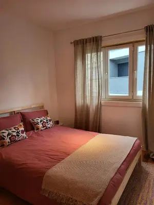 a bedroom with a large bed with a window at Casa da travessa familial e com terraço in Porto