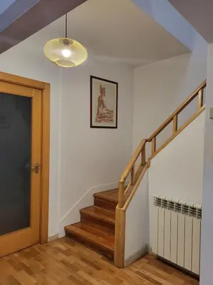 a hallway with a staircase and a light fixture at Casa da travessa familial e com terraço in Porto
