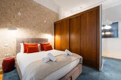 a bedroom with a large bed with orange pillows at GuestReady - Tempting getaway in Porto in Porto