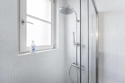 a bathroom with a shower with a window and a shower at GuestReady - Tempting getaway in Porto in Porto
