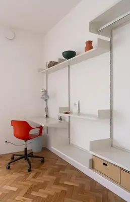an office with white shelves and a red chair at Stylish Flat w/ Terrace & Views by HostWise in Porto