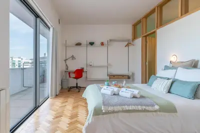 a bedroom with a large bed with towels on it at Stylish Flat w/ Terrace & Views by HostWise in Porto