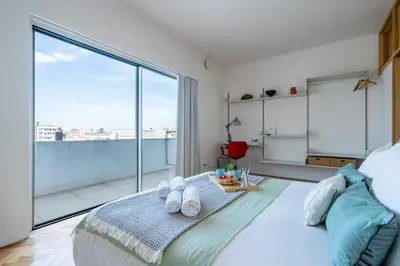 a bedroom with a bed and a large window at Stylish Flat w/ Terrace & Views by HostWise in Porto