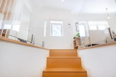 a staircase in a house with wooden floors and a window at Clérigos Loft | 111 Collection in Porto
