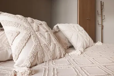 a white bed with white pillows on it at Bleu Alma Apartment in Porto