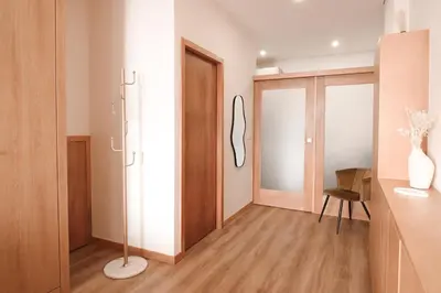 a room with a hallway with a chair and a mirror at Bleu Alma Apartment in Porto