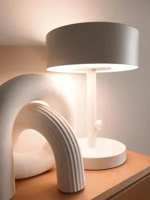 a white lamp on a table with a lamp shade at Bleu Alma Apartment in Porto