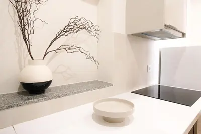 a bathroom with a toilet and a vase on a counter at Bleu Alma Apartment in Porto