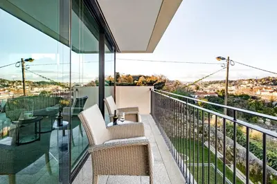 a balcony with chairs and a view of the city at Quinta de Sao Marcos Suite Deluxe in Vila Nova de Gaia
