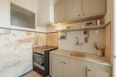 a small kitchen with a sink and a stove at Santa Catarina Flat 2BD with Balcony by Vacationy in Porto