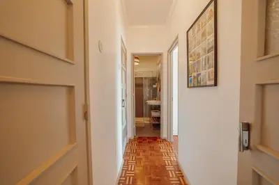 a corridor of a hallway with a door and a floor at Santa Catarina Flat 2BD with Balcony by Vacationy in Porto