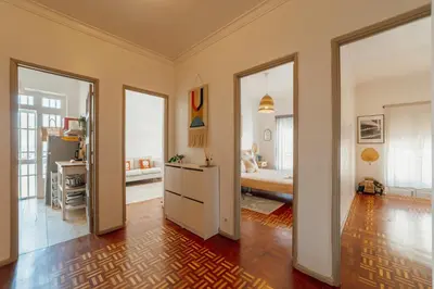 a room with a kitchen and a living room at Santa Catarina Flat 2BD with Balcony by Vacationy in Porto