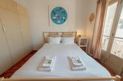 a bedroom with a bed with two towels on it at Santa Catarina Flat 2BD with Balcony by Vacationy in Porto