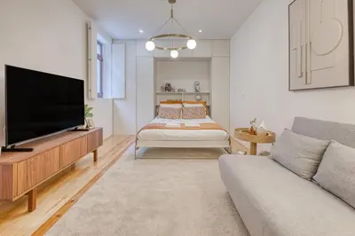 a living room with a television and a couch at OPORTO GUEST Downtown Escape in Porto