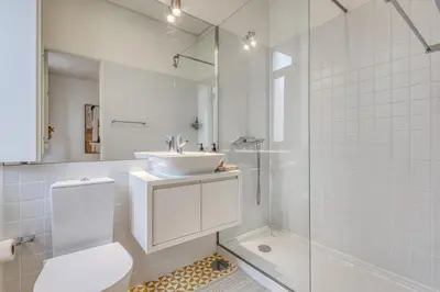 a bathroom with a sink and a toilet and a shower at OPORTO GUEST Downtown Escape in Porto