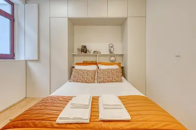 a bedroom with a large bed with two pillows at OPORTO GUEST Downtown Escape in Porto