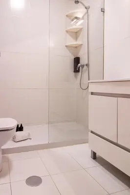 a white bathroom with a shower and a toilet at Santa Catarina Haven by LovelyStay in Porto