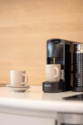 two coffee cups on a counter next to a coffee maker at Santa Catarina Haven by LovelyStay in Porto