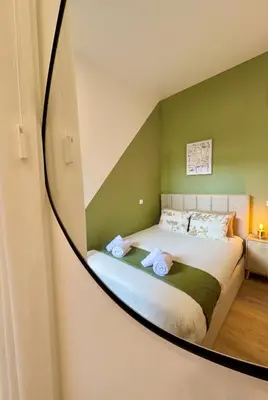a bedroom with a bed with a mirror on the wall at Lili's Garden Priv Terrace TWO flats Laundry by MyMoradia in Porto