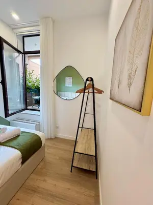 a room with a ladder and a mirror on the wall at Lili's Garden Priv Terrace TWO flats Laundry by MyMoradia in Porto