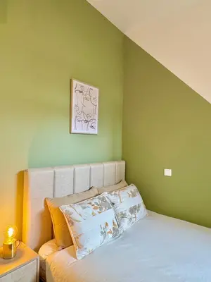 a bedroom with green walls and a bed with pillows at Lili's Garden Priv Terrace TWO flats Laundry by MyMoradia in Porto