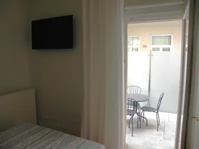 a bedroom with a bed and a table and chairs at Porto Breeze in Porto