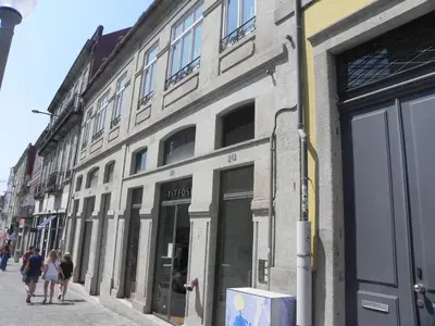 a group of people walking down a street next to a building at Porto Breeze in Porto