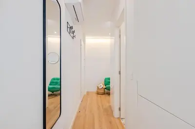 a bedroom with a bed and a flat screen tv on a wall at Studio Dash | 111 Collection in Porto