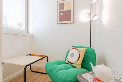 a bedroom with a bed and a flat screen tv at Studio Dash | 111 Collection in Porto