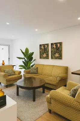 a living room with couches and a coffee table at Happy House - Império in Porto