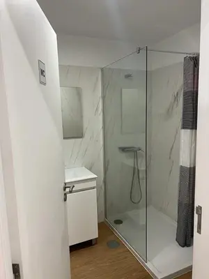 a bathroom with a shower with a glass door at Happy House - Império in Porto