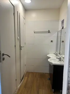a bathroom with a shower and a sink and a mirror at Majestic Hostel Porto in Porto