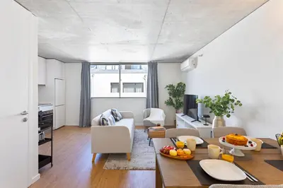 a kitchen and living room with a table and chairs at Premium Apartments with Garage by HostWise in Porto