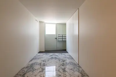 an empty hallway with a door and a tile floor at Premium Apartments with Garage by HostWise in Porto