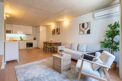 a living room with a couch and a table at Premium Apartments with Garage by HostWise in Porto