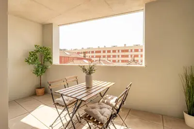 a table and chairs in a room with a window at Premium Apartments with Garage by HostWise in Porto