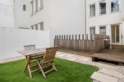 a patio with a wooden table and two chairs at GuestReady - The perfect urban retreat in Porto