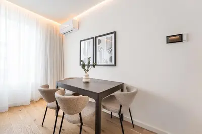 a dining room with a black table and chairs at GuestReady - The perfect urban retreat in Porto