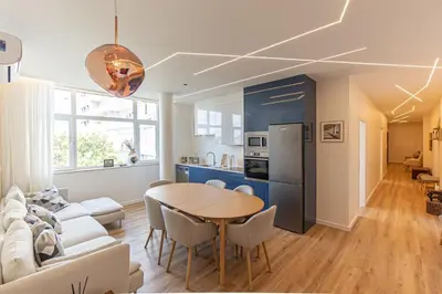 a kitchen and living room with a table and a couch at GuestReady - Urban retreat in Porto in Porto
