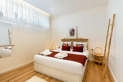 a bedroom with a large white bed with red pillows at GuestReady - Urban retreat in Porto in Porto
