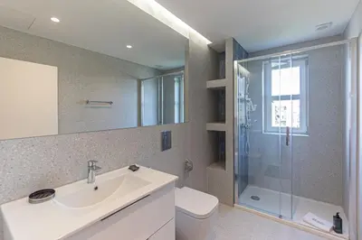 a bathroom with a toilet and a sink and a shower at GuestReady - Urban retreat in Porto in Porto