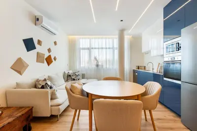 a kitchen and living room with a table and chairs at GuestReady - Urban retreat in Porto in Porto