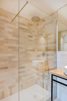 a bathroom with a glass shower with a sink at Balcony Garden Views at Terracotta Collection in Porto