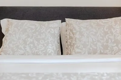 a bed with two pillows and two white pillows at Balcony Garden Views at Terracotta Collection in Porto