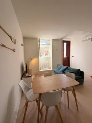 a living room with a table and a couch at Guindais River View I in Porto