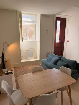 a living room with a table and a couch at Guindais River View I in Porto